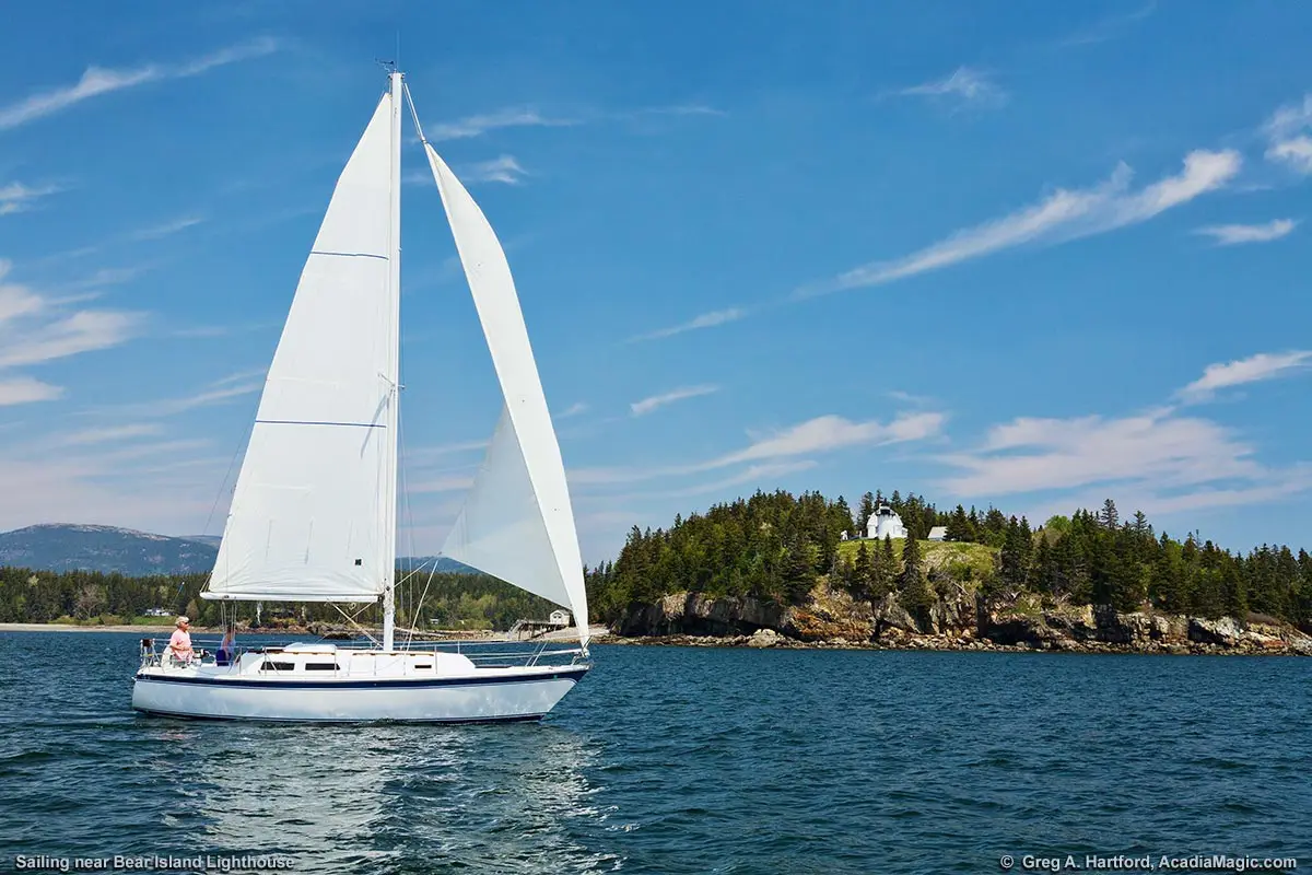 A sailboat passes by the Bear Island Lighthouse in Acadia as it leaves Somes Sound to enter the open ocean.