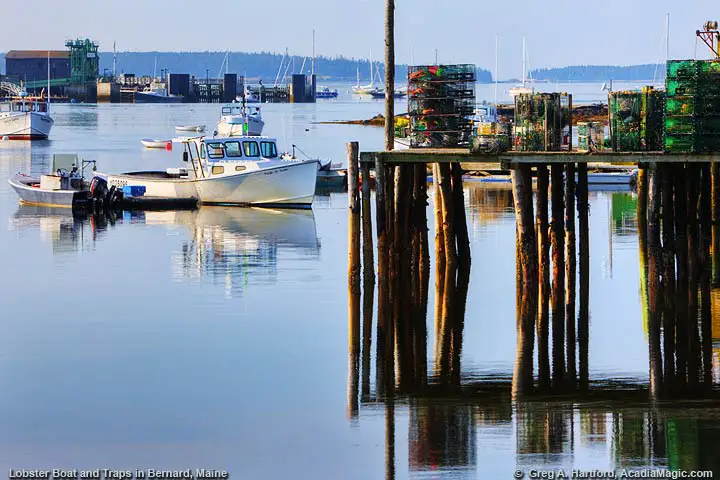 View photo of Maine lobster boat, lobster traps, and view of Bass Harbor, Maine.