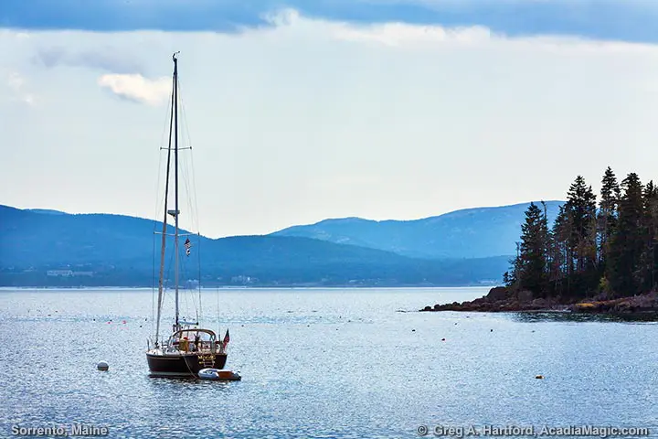 Sailboat in harbor with view of Bar Harbor