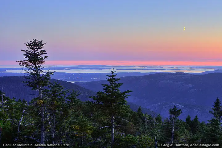 Twilight view of Southwest Harbor from cadillac Mountain with setting moon