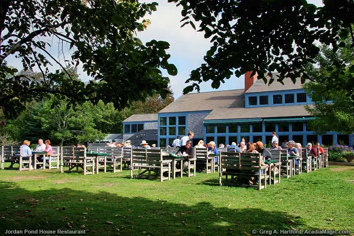 A view of people dining on lawn at the Jordan Pond House restaurant in Acadia