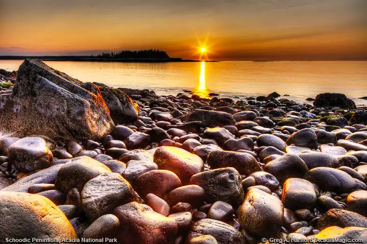 Beautiful golden sunrise with large boulders in foreground