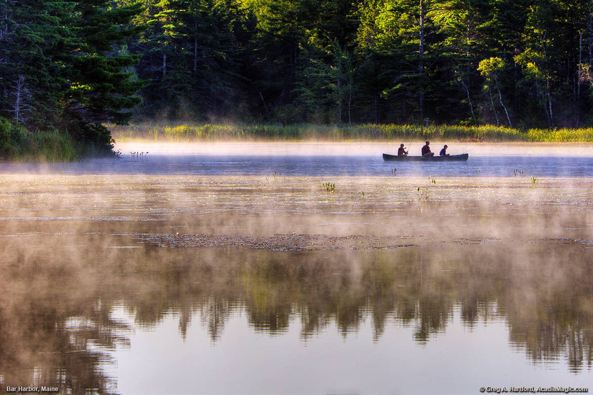 A father and his sons fish on Hamilton Pond in Bar Harbor, Maine.
