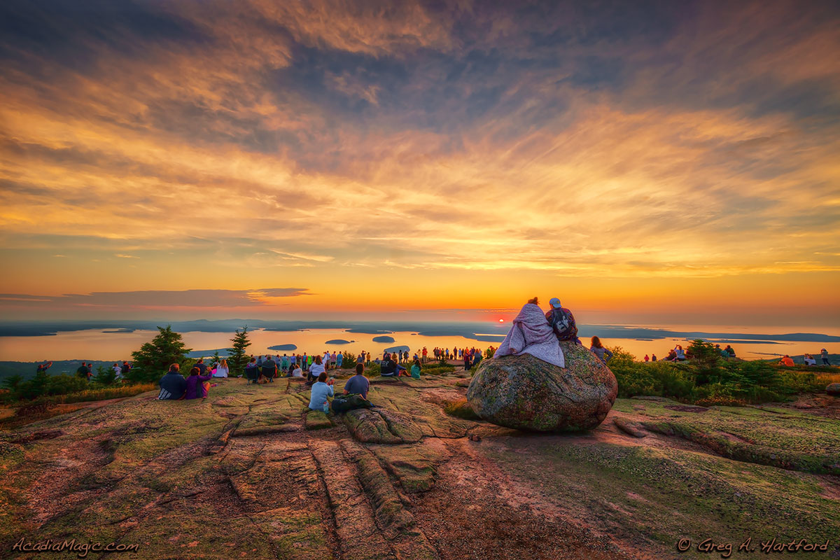 A large group of visitors gather in silence to greet another Cadillac Mountain Sunrise.