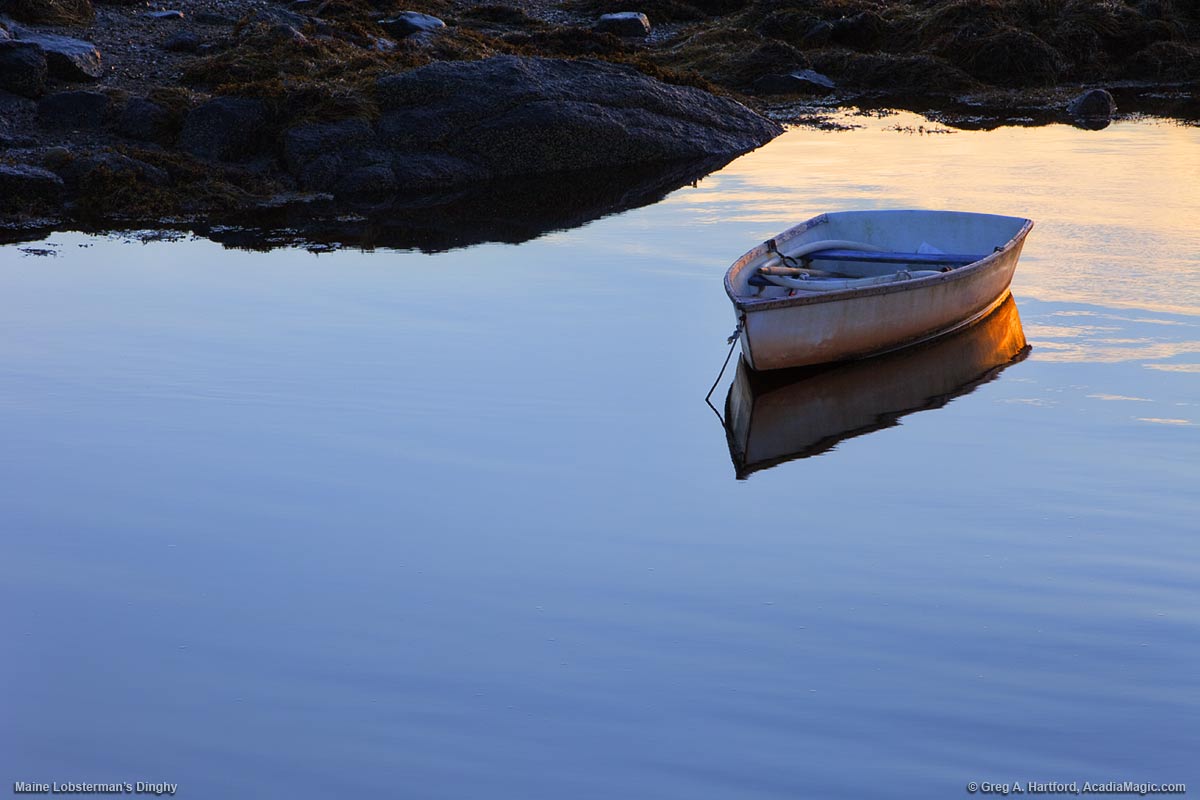 A lone lobster man's dinghy sits in a Maine harbor.