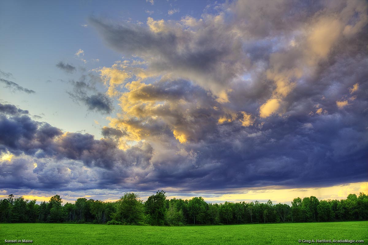 Open sky and clouds above green Maine pasture