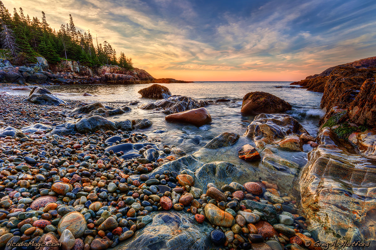 The morning sunlight is just reaching the shore of Hunters Beach in Acadia National Park.