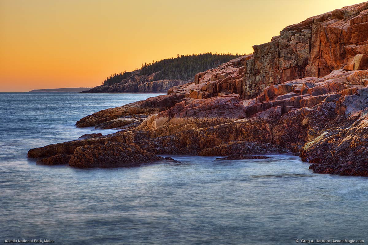 A view of Otter Cliff from just north on the rocky coast in Acadia National Park