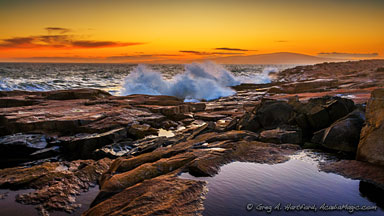 View of Cadillac Mountain in the distance with Schoodic Point waves in the foreground