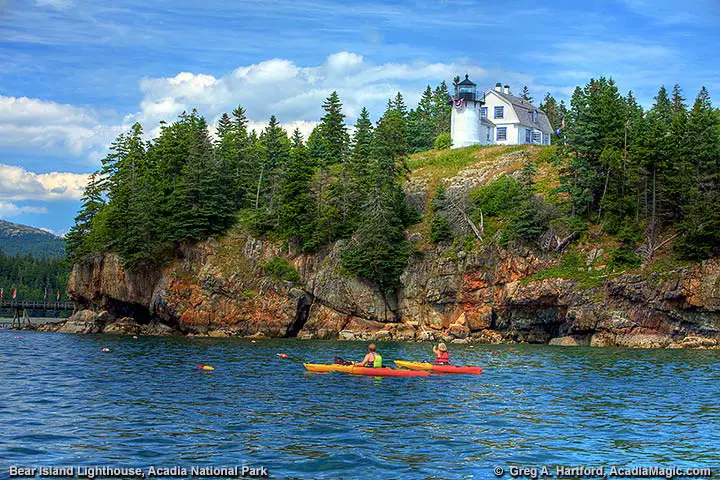 Kayakers near the lighthouse on Bear Island in Acadia National Park, Maine