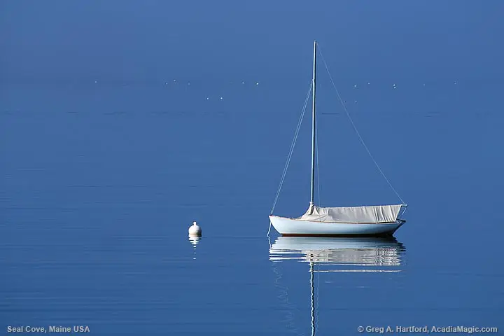 Sailboat with reflection in ocean