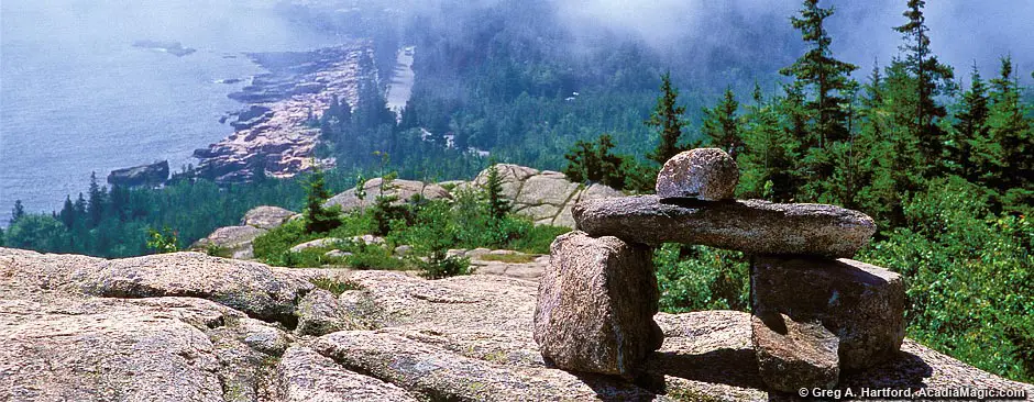 This shows a hiking trail cairn on top of Gorham Mountain in Acadia National Park.