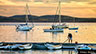Sorrento, Maine harbor scene during sunset with yachts and dinghies in water